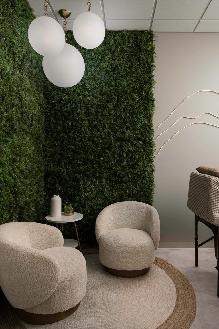 Seating area with moss wall and globe lights in a VIVA Wellness colonic room