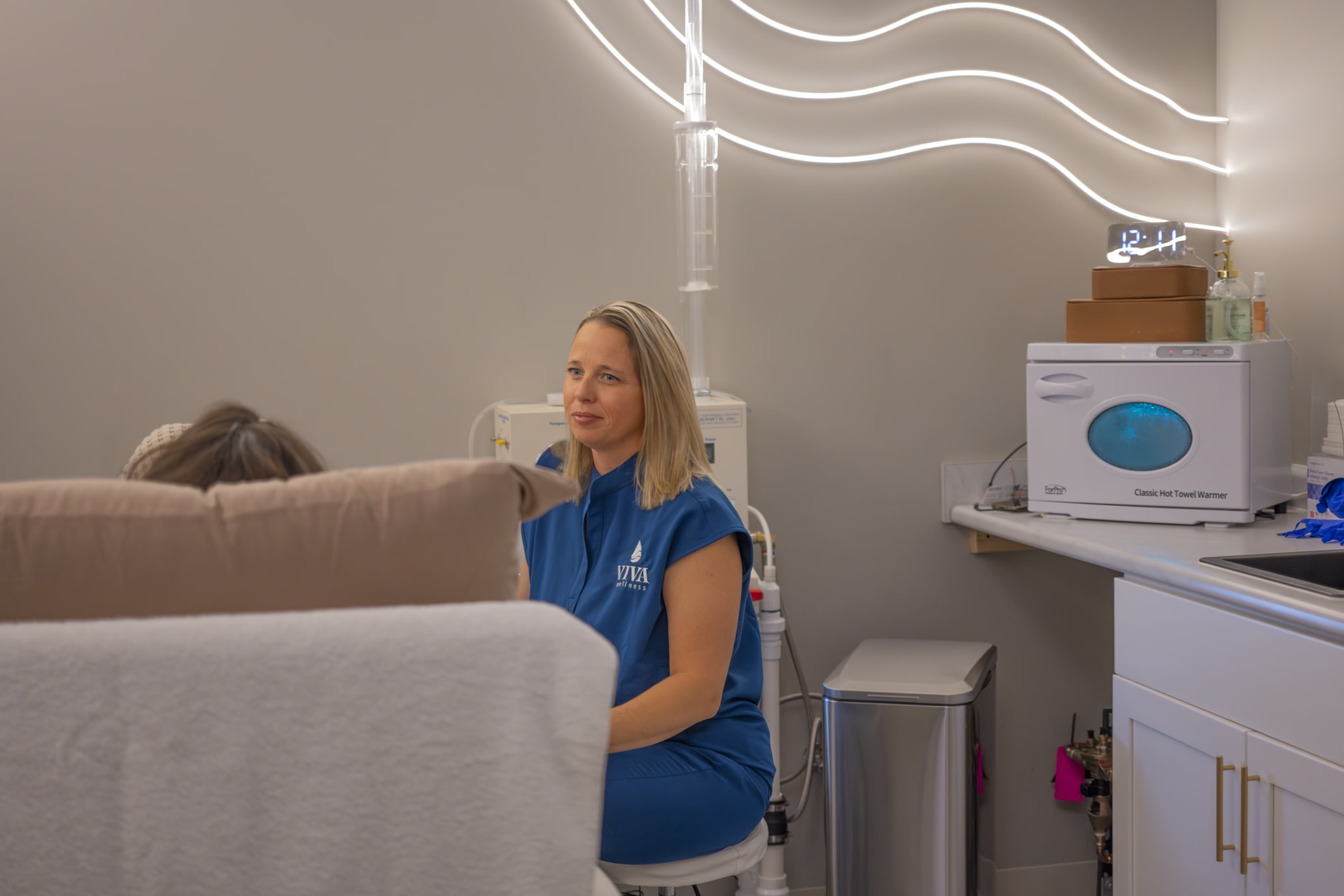 colonic nurse sitting with patient