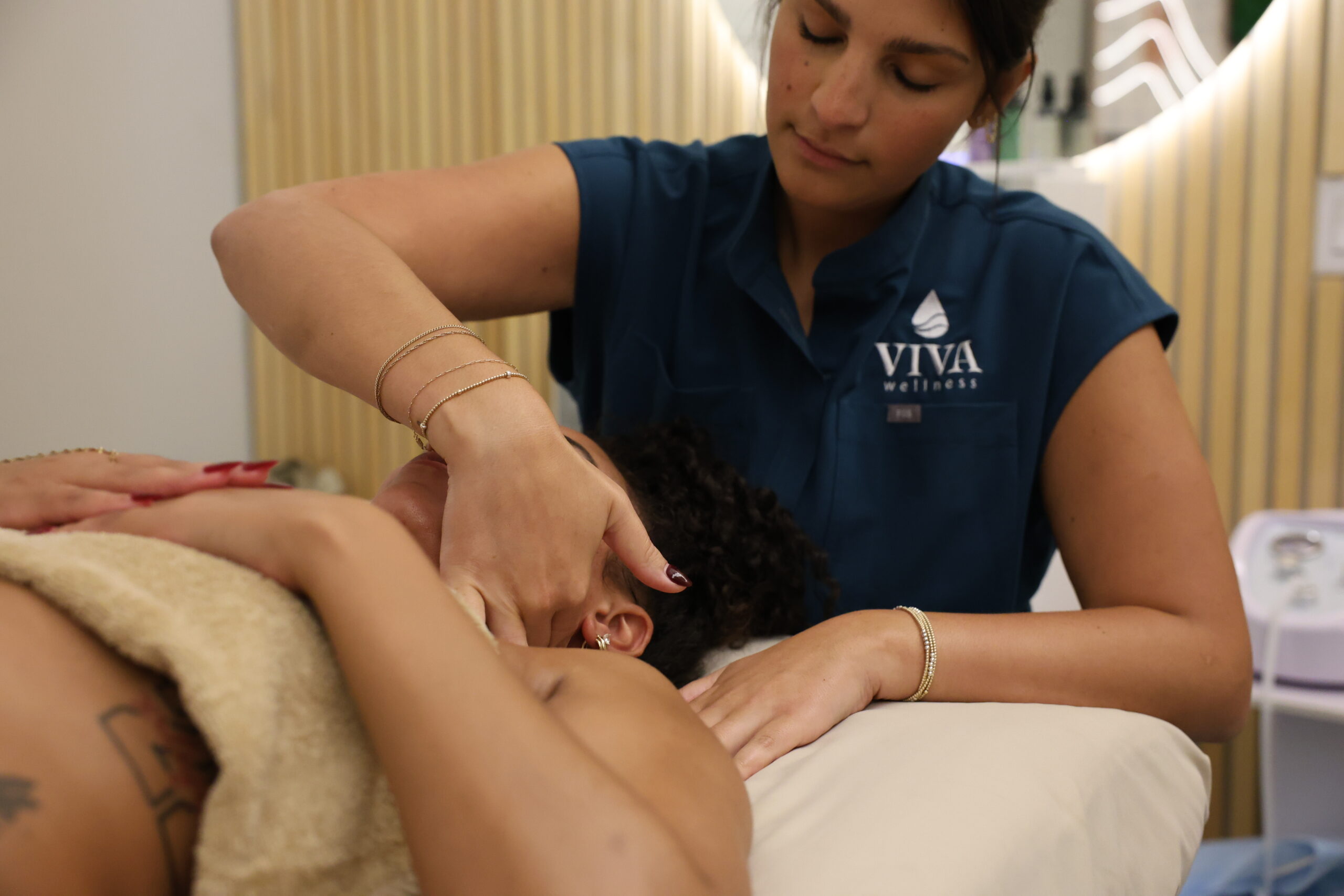 Jaida providing hands-on neck care at VIVA Wellness