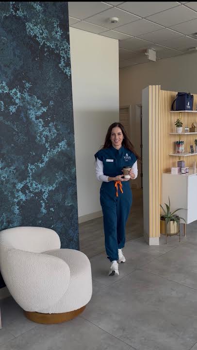VIVA Wellness team member holding coffee in the clinic